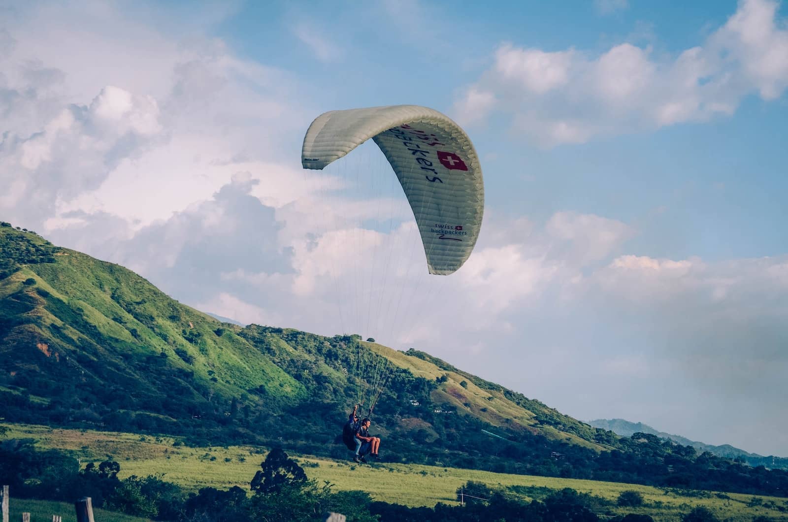 paraglider under blue sky